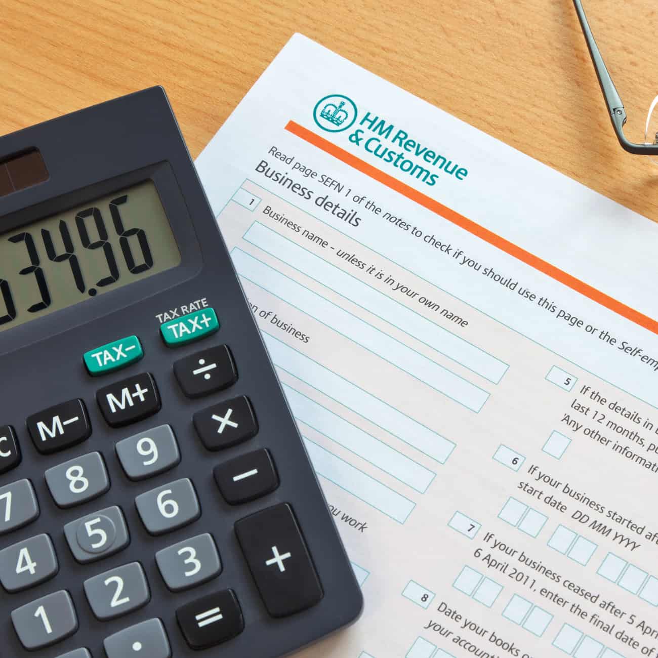 Self employment tax form and calculator on a desk